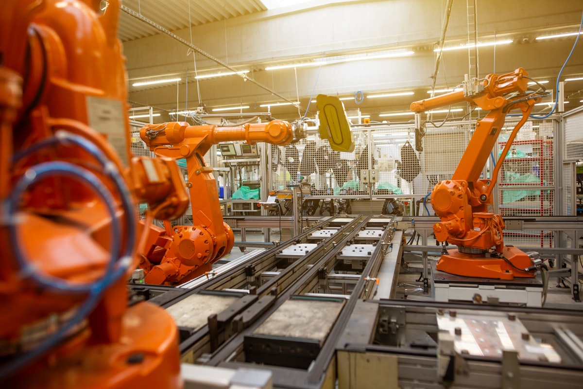 Industrial robotic arm in a manufacturing cell